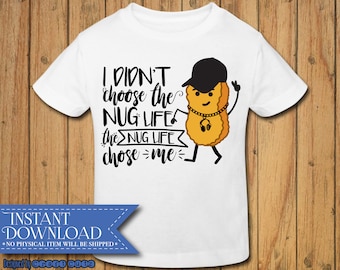 May include: White t-shirt with a black and yellow cartoon chicken nugget wearing a backwards hat, sunglasses, and a gold chain. The text on the shirt reads "I didn't choose the NUG LIFE the NUG LIFE chose me".