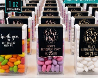 May include: A collection of clear rectangular plastic containers filled with colorful mints, each featuring a black custom label with gold text. Labels display phrases like 'Retire Mint', 'Thank you for celebrating with us', and specific names and dates.