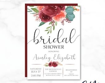 May include: A burgundy and white bridal shower invitation with floral accents. The invitation reads "bridal shower" and "honoring Ainsley Elizabeth". The date, time, and location of the shower are listed below. The invitation also includes information about where the guest of honor is registered.