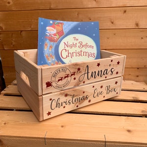 May include: A wooden Christmas Eve box with a red and white North Pole Express Delivery stamp, the words "Anna's Christmas Eve Box" and a copy of the book "The Night Before Christmas".