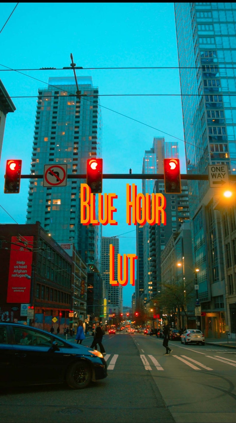 May include: A city street scene at dusk with tall buildings and traffic lights. The text "BLUE HOUR LUT" is superimposed over the image.