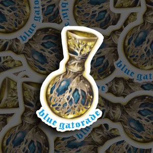 May include: A sticker featuring a blue and gold potion bottle with a tree-like design and the text "blue gatorade" around the bottle.