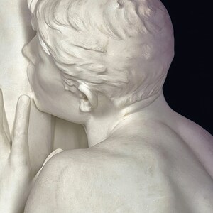 May include: A white marble sculpture of a person with their head tilted back and their mouth open. The sculpture is detailed and realistic, with visible hair, neck, and shoulders.