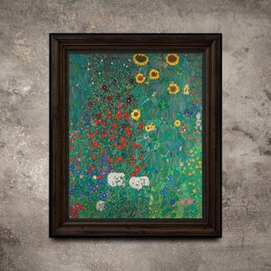May include: Framed art print of a colorful garden scene with sunflowers, red, white, and blue flowers. The artwork is in a dark brown wooden frame and hangs on a textured gray wall. The painting has a vibrant, impressionistic style.