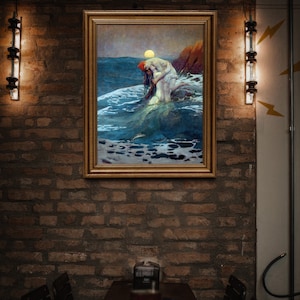 May include: A framed painting depicting a woman in a white dress standing in the ocean, with waves crashing around her. The painting is hung on a brick wall with two light fixtures flanking it.