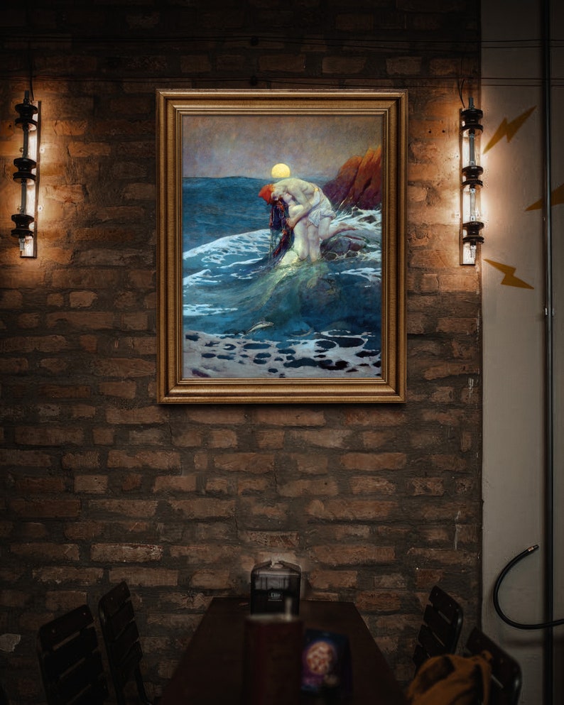 May include: A framed painting depicting a woman in a white dress standing in the ocean, with waves crashing around her. The painting is hung on a brick wall with two light fixtures flanking it.