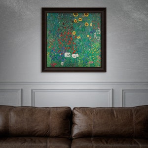 May include: A framed artwork featuring a vibrant floral landscape with sunflowers, red, white, and blue flowers, and lush green foliage. The artwork is displayed on a gray wall above a brown leather sofa.