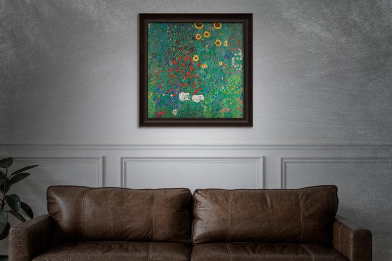 May include: A framed artwork featuring a vibrant floral landscape with sunflowers, red, white, and blue flowers, and lush green foliage. The artwork is displayed on a gray wall above a brown leather sofa.