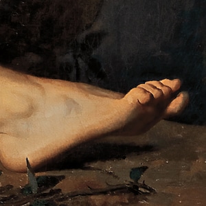 May include: A close-up of a bare foot resting on a dark brown surface. The foot is slightly bent at the ankle and the toes are curled.