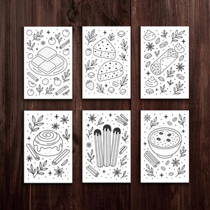 May include: Six black and white illustrations of desserts on white cards. The desserts include a stack of pastries, slices of cake, a cannoli, a cinnamon roll, churros, and a bowl of rice pudding. Each card has decorative elements.