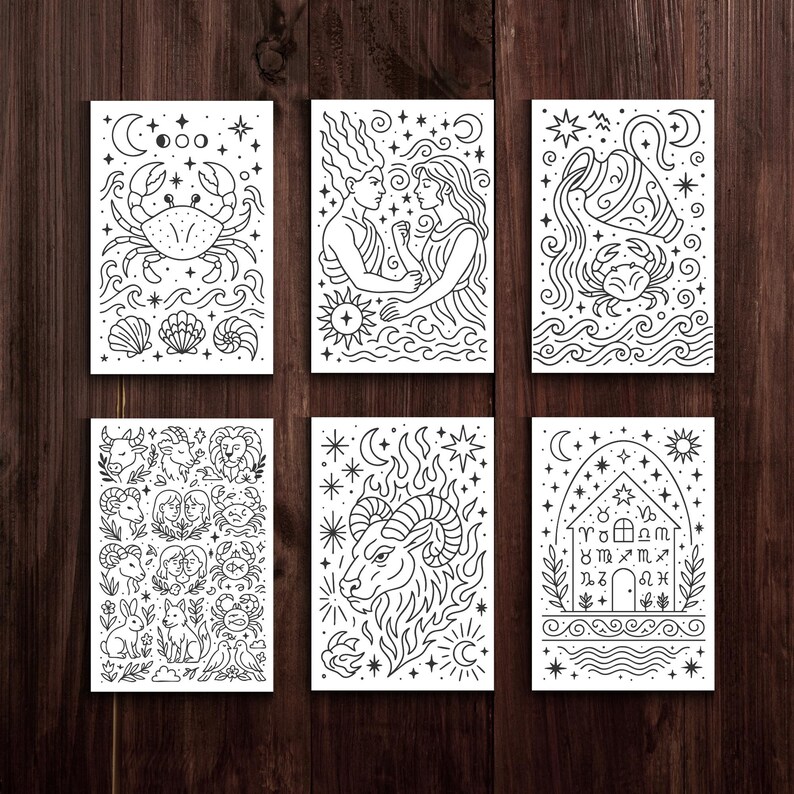 May include: Six black and white art prints featuring zodiac illustrations. Each print showcases detailed line art of astrological symbols, including a crab, figures, and an ram. The prints are arranged on a dark wood surface.