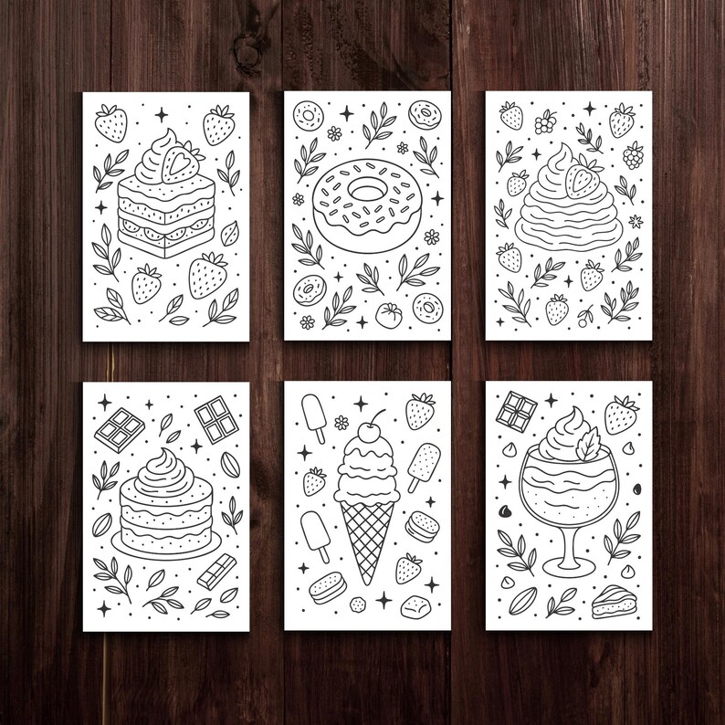 May include: Six black and white dessert-themed art prints. Each print features a different dessert, including a layered cake, donut, ice cream cone, and parfait. The illustrations are surrounded by decorative elements like strawberries and leaves.