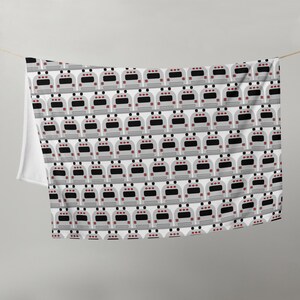 May include: A white fabric with a repeating pattern of gray school buses. Each bus has red taillights and black windows.