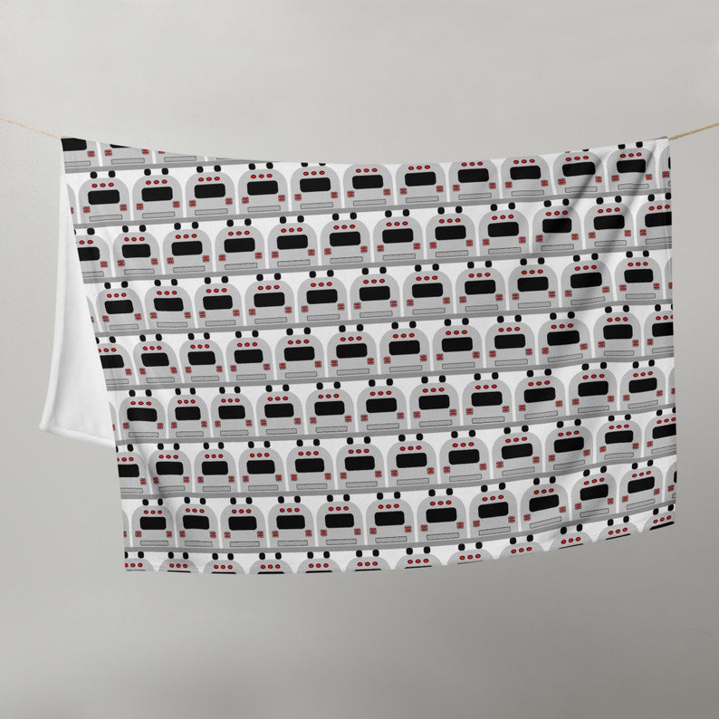 May include: A white fabric with a repeating pattern of gray school buses. Each bus has red taillights and black windows.