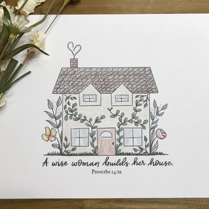 May include: A hand-drawn illustration of a house with vines growing up the sides. The house has a heart-shaped chimney and a pink door. The text "A wise woman builds her house. Proverbs 14:1a" is below the house.