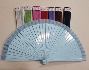 May include: A light blue hand fan with a matching handle, displayed with bundles of colorful threads in various shades. The threads are white, green, pink, red, purple, brown, and black.
