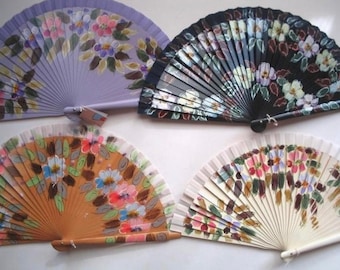May include: Four hand-painted folding fans with floral designs. The fans are made of wood and have a variety of colors, including purple, black, brown, and white.