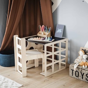 Close-up view of an organized kids study station featuring a convertible desk and chair.