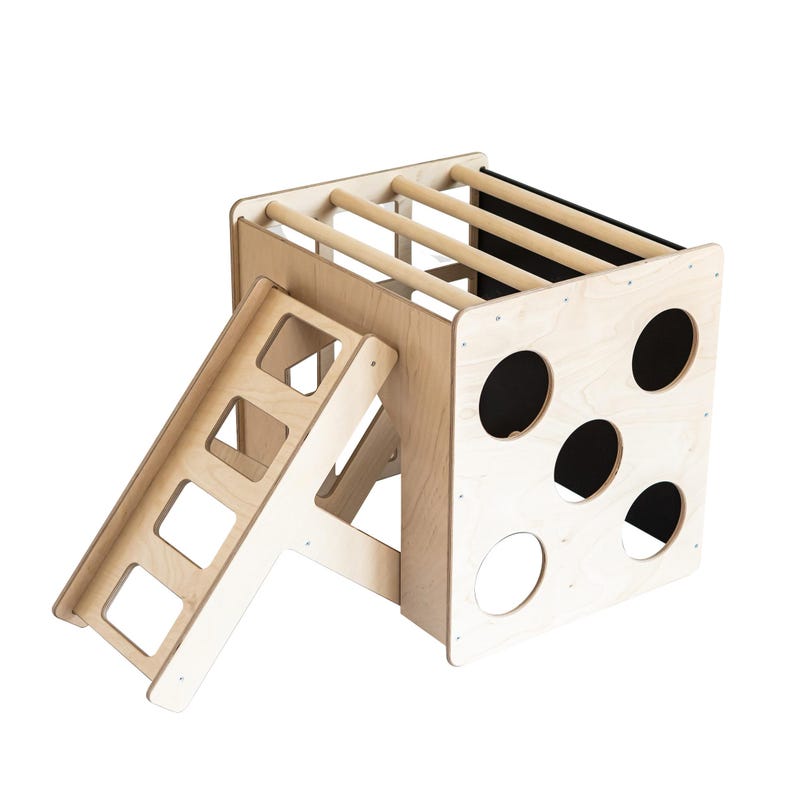 Studio shot of a birch plywood indoor climbing cube with an attached ramp.