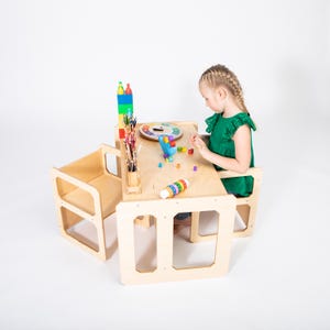 Young girl playing with wooden educational toys at a natural birch plywood weaning table set.