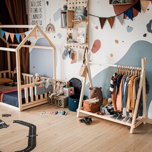 Wooden kids garment rack arranged in a Montessori playroom layout, making a thoughtful Christmas gift for growing toddlers.