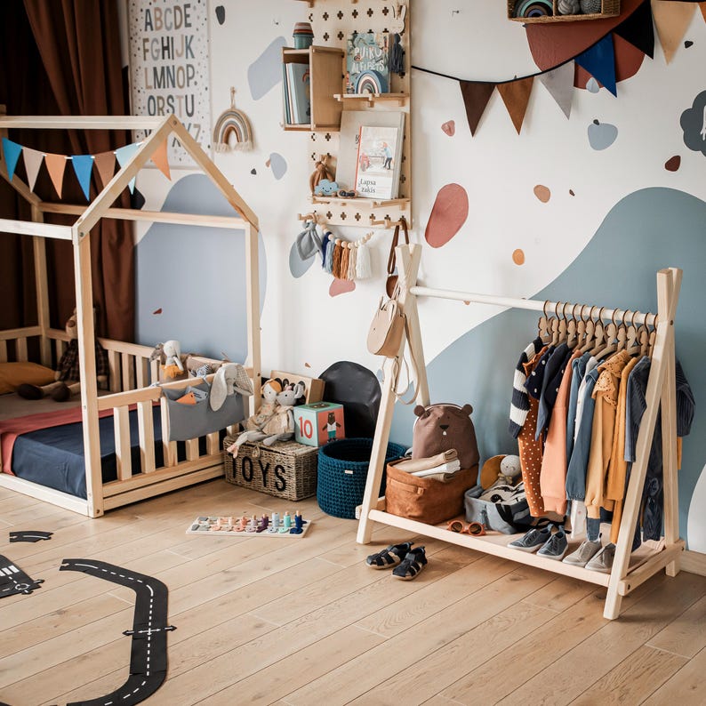 Wooden kids garment rack arranged in a Montessori playroom layout, making a thoughtful Christmas gift for growing toddlers.