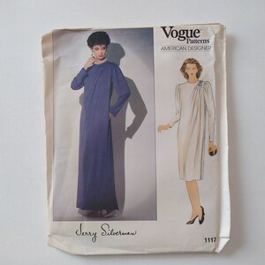 May include: Vogue Patterns American Designer sewing pattern for a dress by Jerry Silverman, pattern number 1117. The pattern shows two models wearing the dress in different colors.