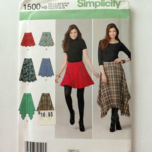 May include: A Simplicity 1500 sewing pattern envelope for skirts in sizes 6-14. The front displays illustrations of five skirt variations labeled A through E, alongside photographs of two skirts: a red skirt and a plaid handkerchief-hem skirt.