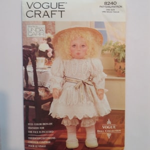May include: A vintage Vogue Craft doll pattern, number 8240, for a doll wearing a white dress with a lace trim and a straw hat. The pattern includes a full color iron-on transfer for the face.