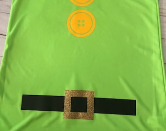 May include: A lime green tank top with two large yellow buttons and a black belt with a gold buckle. The tank top is a costume for a character from a popular movie.