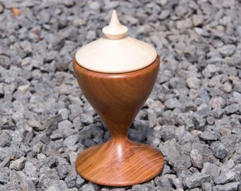 Turned jewelry box in plum wood with lid made of maple