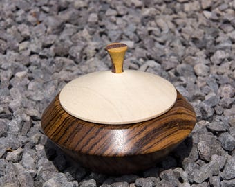 Turned can made of zebrano wood with a lid made of a white beech