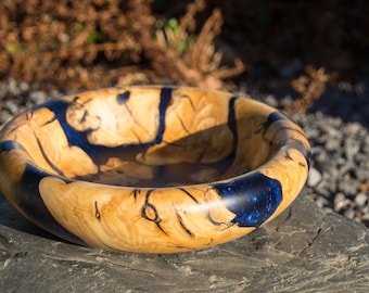 Large turned bowl made of root pieces with blue resin