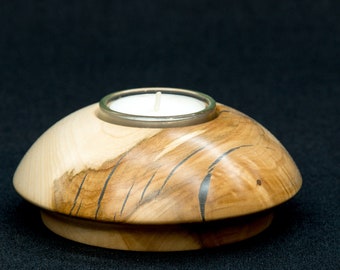 Turned holder for a hornbeam tealight including tealight and glass insert.