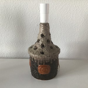 Rare danish vintage ceramic lamp base in nice and warm brown colors .