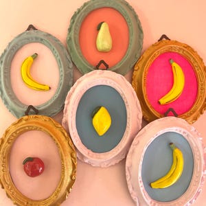 Oval frame with ceramic fruit: banana, apple, and strawberry. Hanging ceramic fruit decor, ceramic fruit wall art, perfect for kitchen