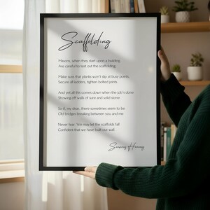 a wooden chair with a framed poem titled "Scaffolding" leaning against a wall.