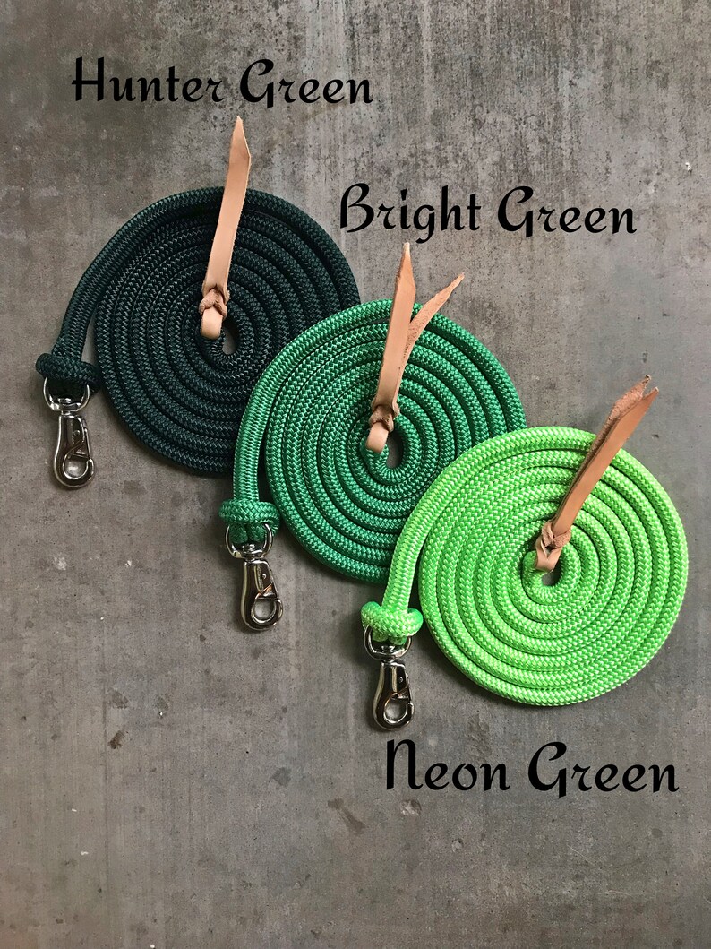 May include: Three coiled ropes in different shades of green, hunter green, bright green, and neon green. Each rope has a brown leather loop and a silver clip.