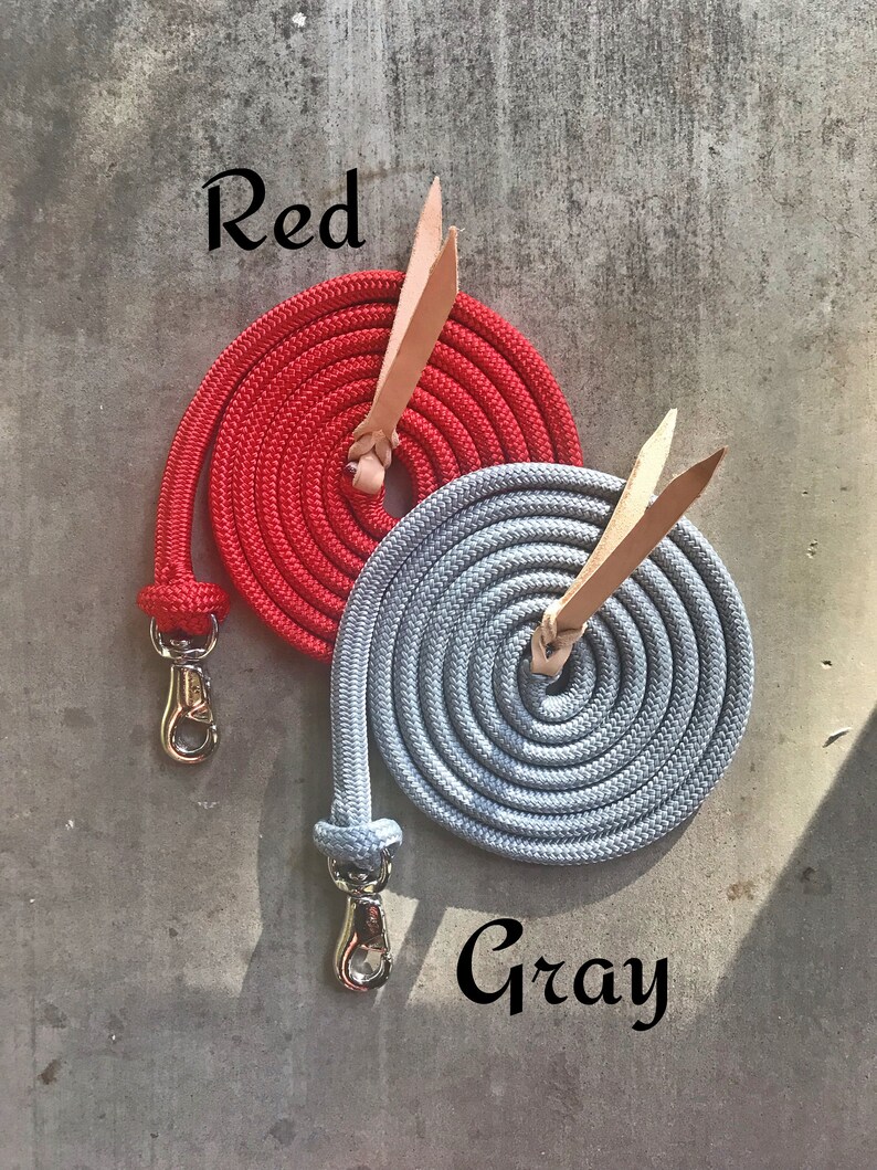 May include: Two coiled ropes with leather handles and metal clasps. One rope is red and the other is grey. The text "Red" is above the red rope and the text "Gray" is below the grey rope.