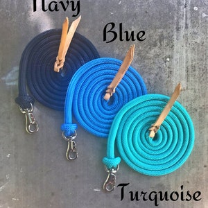 May include: Three coiled ropes with leather straps and metal clips. The ropes are navy blue, blue, and turquoise.