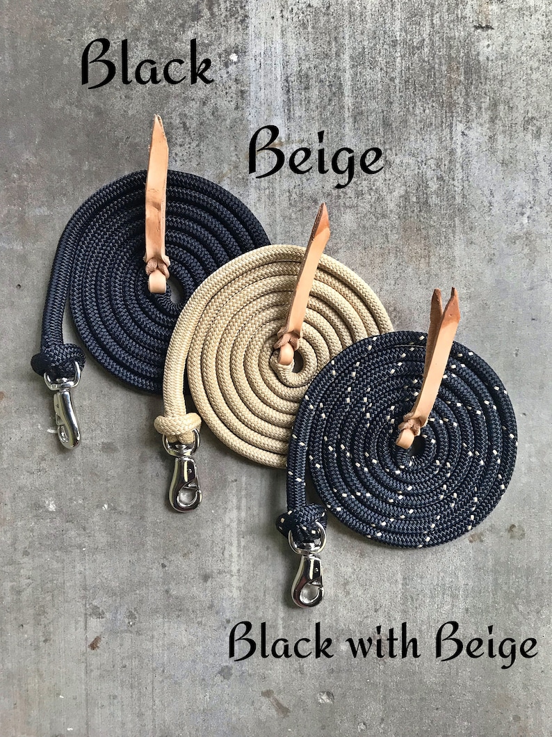 May include: Three coiled ropes with leather ends and metal clasps. The ropes are black, beige, and black with beige speckles. The ropes are labelled "Black", "Beige", and "Black with Beige".