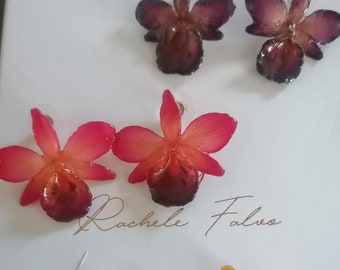 pares de aretes de orquídeas naturales incorporados en resina con ganchos plateados