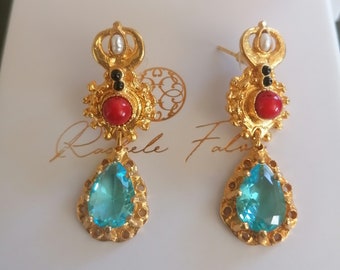 Etruscan earrings in gold on bronze and finished with red corals, obsidian and drop-cut blue topazes.