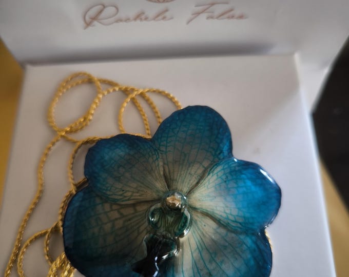 Blue Vanda orchid embedded in resin and finished with gold on bronze adjustable slider