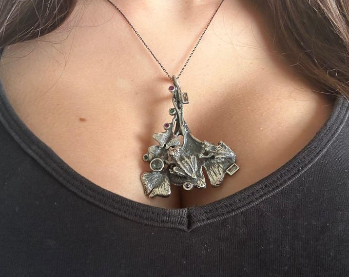 silver pendant with frogs on leaves, complete with chain