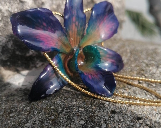 Uniquely colored orchid necklace embedded in resin and adjustable gold-plated slider