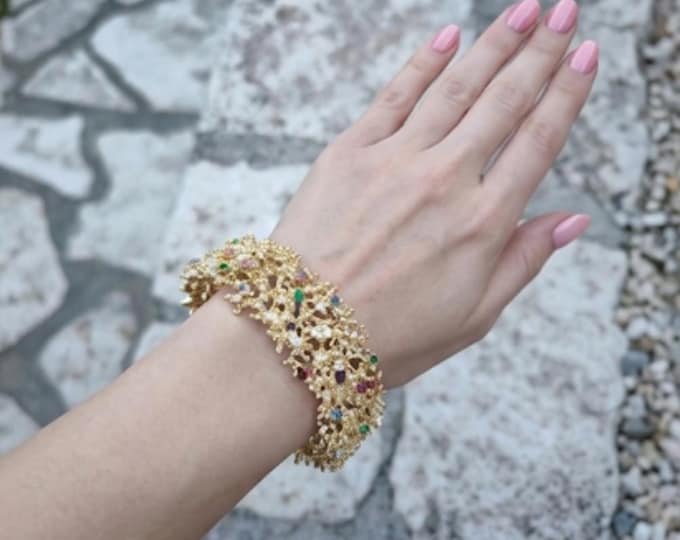 Adjustable gold-plated bronze band bracelet with multi-colored topazes and coral-style design