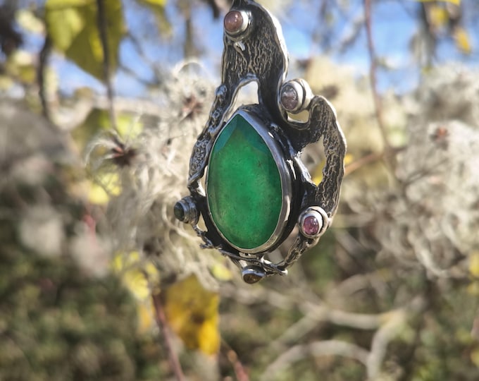 Organically crafted silver pendant complete with chain featuring a central drop of green Imperial Jade and mixed-color tourmalines.