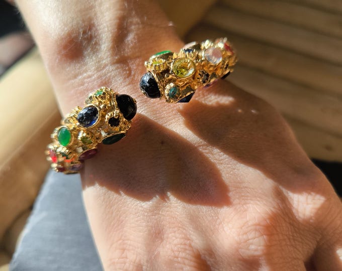 Etruscan-Byzantine style rigid bracelet made of gold on bronze and finished with natural topazes and zircons, with central black onyxes.