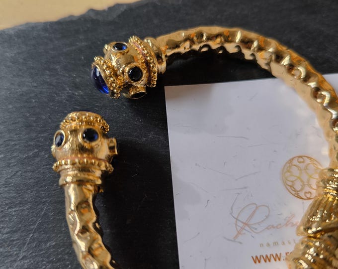 Rigid bracelet in gold on bronze and natural blue topazes